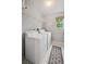 Bright laundry room with side-by-side washer and dryer and wire shelving for storage at 2813 Central Park Blvd, Denver, CO 80238