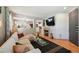 Open-concept living room featuring a cozy fireplace and hardwood floors, creating a warm and inviting atmosphere at 2813 Central Park Blvd, Denver, CO 80238