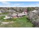 Charming aerial view of the home and beautifully manicured lawn with mature trees at 21 Huntwick Ln, Cherry Hills Village, CO 80113