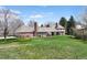 Picture of the home's lush backyard and brick exterior at 21 Huntwick Ln, Cherry Hills Village, CO 80113