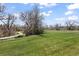 Picturesque backyard featuring a winding path through a lush green lawn at 21 Huntwick Ln, Cherry Hills Village, CO 80113