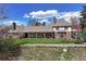 Covered patio and lush backyard with mature trees at 21 Huntwick Ln, Cherry Hills Village, CO 80113