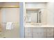 Bathroom with blue floral wallpaper, white vanity, and a shower with glass door at 21 Huntwick Ln, Cherry Hills Village, CO 80113