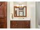Bathroom featuring a wood vanity, marble countertop, gold fixtures, and a large mirror at 21 Huntwick Ln, Cherry Hills Village, CO 80113