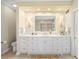 Bright bathroom with marble countertops, double sinks, and recessed lighting for a luxurious feel at 21 Huntwick Ln, Cherry Hills Village, CO 80113