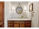 Charming bathroom with modern vanity, framed mirror and sconce lighting at 21 Huntwick Ln, Cherry Hills Village, CO 80113