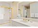 Bright bathroom featuring gold fixtures, decorative wall trim, and a shower at 21 Huntwick Ln, Cherry Hills Village, CO 80113