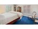 Bedroom with dark blue carpet, two windows, and shutter style window coverings at 21 Huntwick Ln, Cherry Hills Village, CO 80113