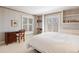 Bedroom with blue wallpaper, built-in shelving, and shuttered windows at 21 Huntwick Ln, Cherry Hills Village, CO 80113