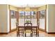 Dining room with natural light, thanks to the surrounding large window, and classic wooden furniture at 21 Huntwick Ln, Cherry Hills Village, CO 80113