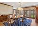Traditional dining room featuring hardwood floors, large windows, and a wooden table at 21 Huntwick Ln, Cherry Hills Village, CO 80113