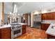 Elegant kitchen with stainless steel appliances, tiled flooring, and an open layout at 21 Huntwick Ln, Cherry Hills Village, CO 80113