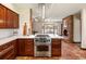 Beautiful kitchen with white countertops, a brick fireplace, and stainless steel appliances at 21 Huntwick Ln, Cherry Hills Village, CO 80113