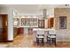 Spacious kitchen featuring brick accents, a brick island, and stainless steel appliances at 21 Huntwick Ln, Cherry Hills Village, CO 80113