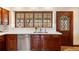 Kitchen with dark wood cabinetry, stainless steel appliances, and a bright quartz countertop at 21 Huntwick Ln, Cherry Hills Village, CO 80113