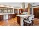 Well-appointed kitchen featuring an island with seating and stainless steel appliances at 21 Huntwick Ln, Cherry Hills Village, CO 80113