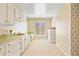 Laundry room with wallpaper, ample counter space, and washer and dryer at 21 Huntwick Ln, Cherry Hills Village, CO 80113