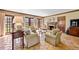 Comfortable living room with a fireplace, wooden trim and lots of natural light at 21 Huntwick Ln, Cherry Hills Village, CO 80113