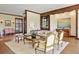 Bright living room with elegant fireplace, wood trim and hardwood floors at 21 Huntwick Ln, Cherry Hills Village, CO 80113