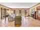 Comfortable living room with a fireplace, wooden trim and lots of natural light at 21 Huntwick Ln, Cherry Hills Village, CO 80113