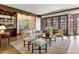 Bright living room with elegant fireplace, wood trim and hardwood floors at 21 Huntwick Ln, Cherry Hills Village, CO 80113