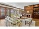 Bright living room with elegant fireplace, wood trim and hardwood floors at 21 Huntwick Ln, Cherry Hills Village, CO 80113