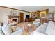 Bright living room showcasing a fireplace, built-in bookshelves, and ample seating at 21 Huntwick Ln, Cherry Hills Village, CO 80113
