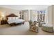 Spacious main bedroom featuring a sitting area, large windows, and neutral decor throughout at 21 Huntwick Ln, Cherry Hills Village, CO 80113
