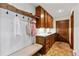 Mudroom with white walls, custom cabinetry, and terra cotta tile flooring at 21 Huntwick Ln, Cherry Hills Village, CO 80113