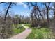 Scenic walking path winding through a tranquil green space with trees at 21 Huntwick Ln, Cherry Hills Village, CO 80113
