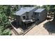 Aerial view of the home featuring a spacious deck, fenced yard and mature landscaping at 23495 Bluestem Dr, Golden, CO 80401