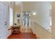 Welcoming foyer with tile flooring, a charming side table, and a staircase leading to the upper level at 23495 Bluestem Dr, Golden, CO 80401