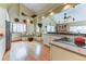Bright kitchen featuring light cabinets, wood floors, breakfast nook with vaulted ceilings, and an electric cooktop island at 23495 Bluestem Dr, Golden, CO 80401