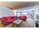 Bright living room with red sofas, a rustic coffee table, and natural light at 23495 Bluestem Dr, Golden, CO 80401