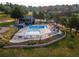 Aerial view of a community pool area with lounge chairs, picnic area, and landscaping at 23495 Bluestem Dr, Golden, CO 80401
