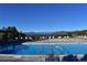 Community pool with lounge chairs overlooking scenic mountain views at 23495 Bluestem Dr, Golden, CO 80401