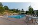 Outdoor community swimming pool with lap lanes, lounge chairs, and scenic hillside views at 23495 Bluestem Dr, Golden, CO 80401