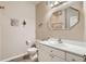A well-lit bathroom featuring a unique mirror and neutral color palette at 8465 S Holland Way # 101, Littleton, CO 80128
