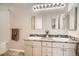 Bright bathroom with double sinks, granite countertops, neutral cabinetry, and brushed nickel hardware at 8465 S Holland Way # 101, Littleton, CO 80128