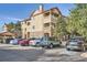 Exterior view of a condo building with well-maintained landscaping and ample parking spaces at 8465 S Holland Way # 101, Littleton, CO 80128