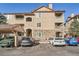 Exterior of a multi-story condo building featuring stone accents, balconies, and convenient parking at 8465 S Holland Way # 101, Littleton, CO 80128
