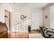 Hallway view features wood floors, neutral walls, white doors, and a built-in desk at 8465 S Holland Way # 101, Littleton, CO 80128