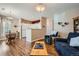 A living room and kitchen space with wood floors, neutral walls, and comfortable furniture at 8465 S Holland Way # 101, Littleton, CO 80128