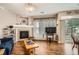 Bright living room featuring a fireplace, wood floors, a sliding glass door, and a TV at 8465 S Holland Way # 101, Littleton, CO 80128