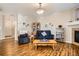 Cozy living room with a fireplace, wood floors, and natural light from a window at 8465 S Holland Way # 101, Littleton, CO 80128
