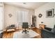 Home office with wood floors, neutral walls, a large window, and a clear desk with an office chair at 8465 S Holland Way # 101, Littleton, CO 80128