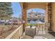 Charming porch with stone columns, outdoor furniture, and scenic views of the community parking at 8465 S Holland Way # 101, Littleton, CO 80128