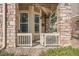 Inviting porch with a view of the exterior, accessible by a gate, and featuring stone accents at 8465 S Holland Way # 101, Littleton, CO 80128