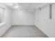 Finished basement area with gray carpeting, bright lighting, and a window for natural light at 3212 Uvalda St, Aurora, CO 80011