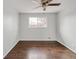 This bedroom has hard wood floors, natural light from the large window and neutral walls at 3212 Uvalda St, Aurora, CO 80011